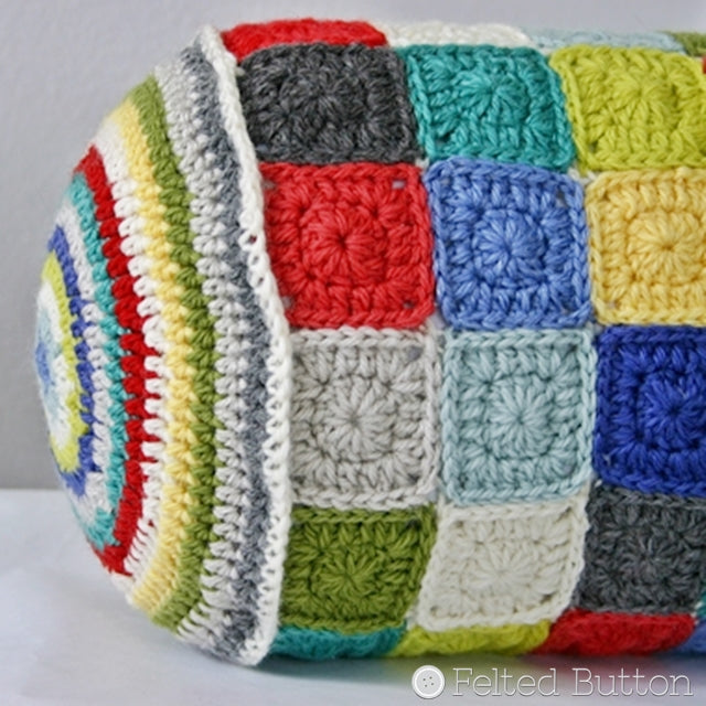 Bolster crochet pillow iwth circular stripes on ends and small granny squares, Susan Carlson of Felted Button | Colorful Crochet Patterns