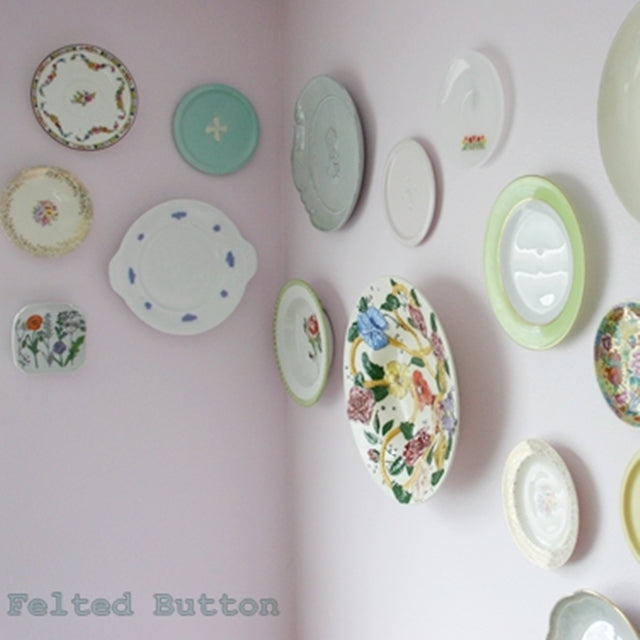 Vintage and colorful plates hanging on pink wall, by Susan Carlson of Felted Button | Colorful Crochet Patterns