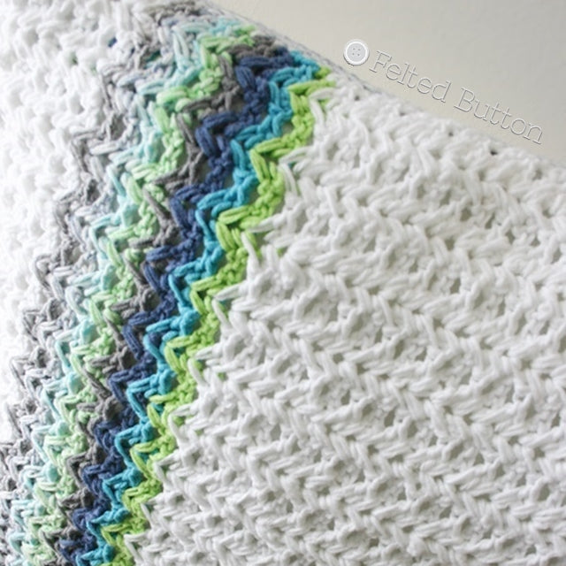 Herringbone crochet stitch, pillow cover instruction included in Taking Shape Pillow crochet pattern by Susan Carlson of Felted Button | Colorful Crochet Patterns, white pillow with blues and green stripes