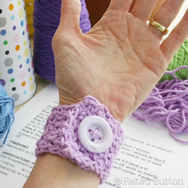 Purple crochet cuff with large lavender button, easy beginner crochet project by Susan Carlson of Felted Button | Colorful Crochet Patterns