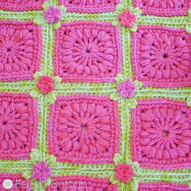 Melon and green textured crochet motifs in rug with small flowers at centers, Susan Carlson of Felted Button | Colorful Crochet Patterns, Melon Berry Rug
