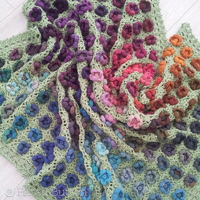Monet's Garden Throw, crochet afghan pattern with colorful watercolor yarn in textured flowers and green trellis background, crochet pattern by Susan Carlson of Felted Button | Colorful Crochet Patterns