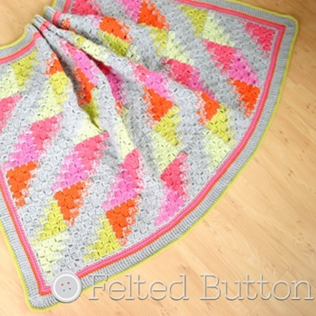 Puzzle Patch Blanket with half squares in C2C, corner to corner crochet stitch pattern in pinks, oranges, yellows and citrine, by Susan Carlson of Felted Button | Colorful Crochet Patterns