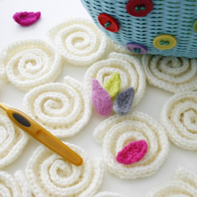White crochet swirls with felted colorful flowers, Susan Carlson of Felted Button | Colorful Crochet Patterns