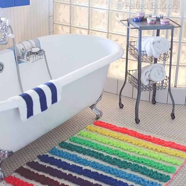 Colorful ruffled rainbow mat in front of white standing tub, Rainbow Ruffles Blanket crochet pattern by Susan Carlson of Felted Button | Colorful Crochet Patterns