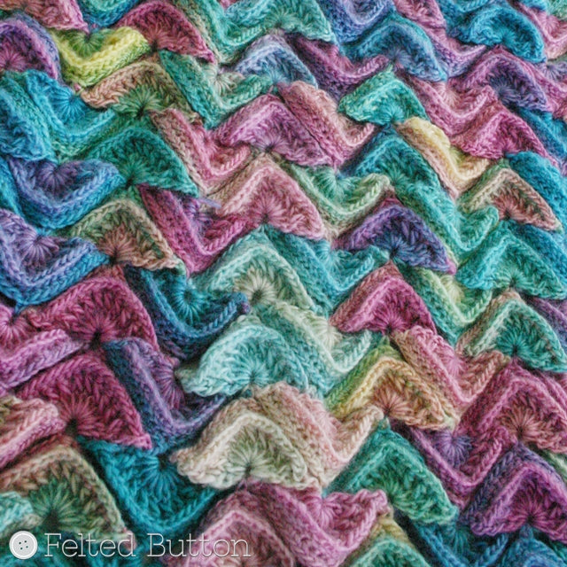 Multi-colored and textured scale shaped crochet motifs joined in blanket, made with Red Heart Unforgettable yarn in Candied color, Sea Song Blanket crochet throw or afghan pattern by Susan Carlson of Felted Button | Colorful Crochet Patterns
