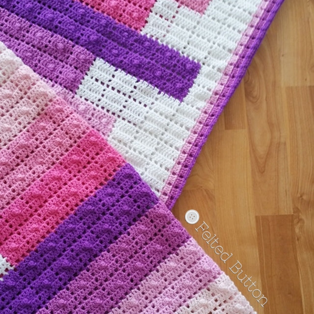 Teetering Tower Blanket crochet pattern in pinks and purples, resembles stacked books on white background, crochet pattern by Susan Carlson of Felted Button | Colorful Crochet Patterns