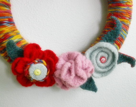 Colorful Felted yarn-wrapped wreath with felted flowers and buttons, by Susan Carlson of Felted Button | Colorful Crochet Patterns