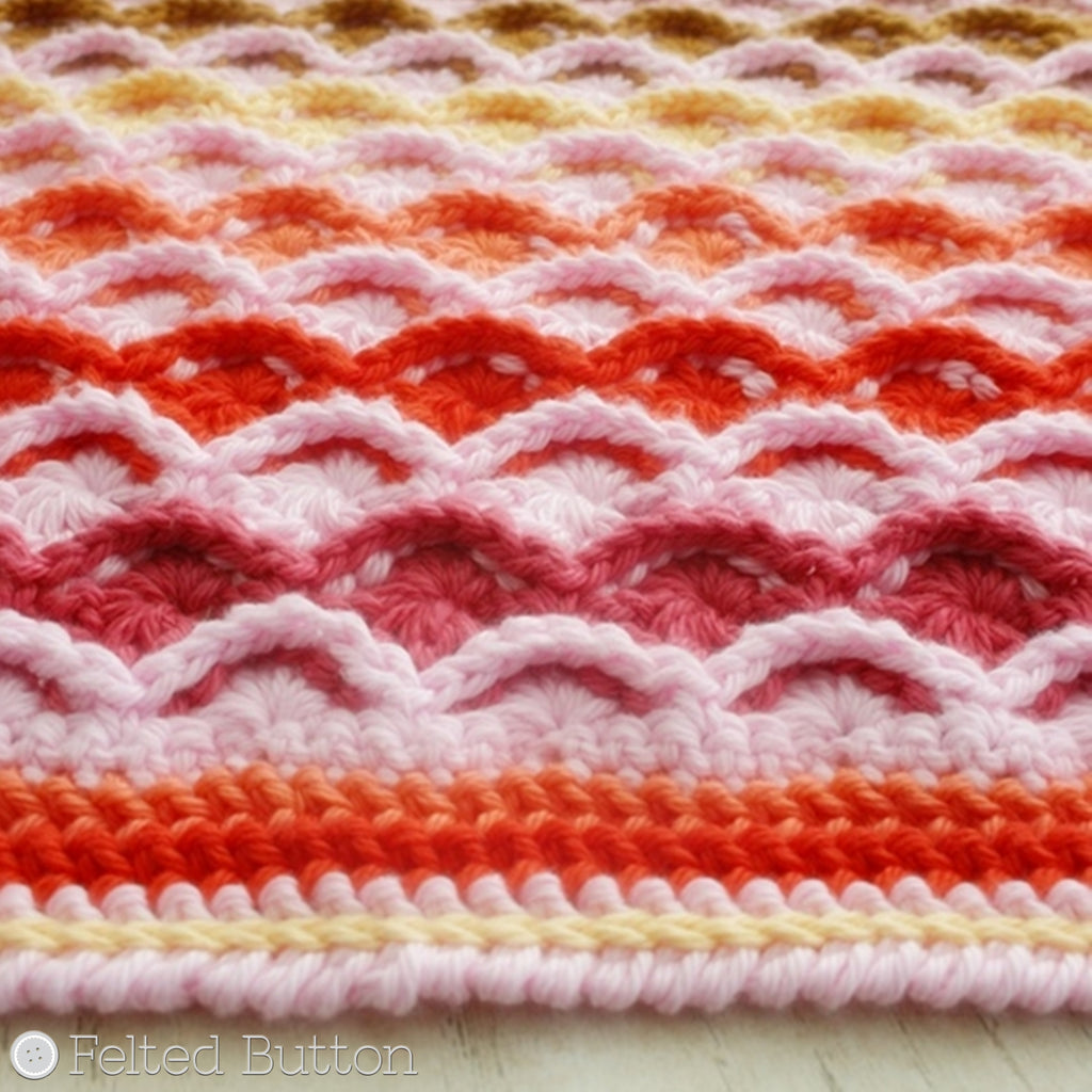 Pink and orange textured crochet blanket made with cotton yarn, designed by Susan Carlson of Felted Button, colorful crochet patterns