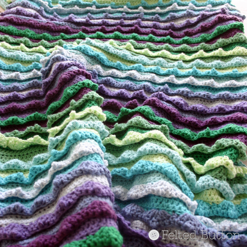 Textured, blue, green and purple blanket with crocheted waves, Eventide Blanket crochet pattern by Susan Carlson of Felted Button