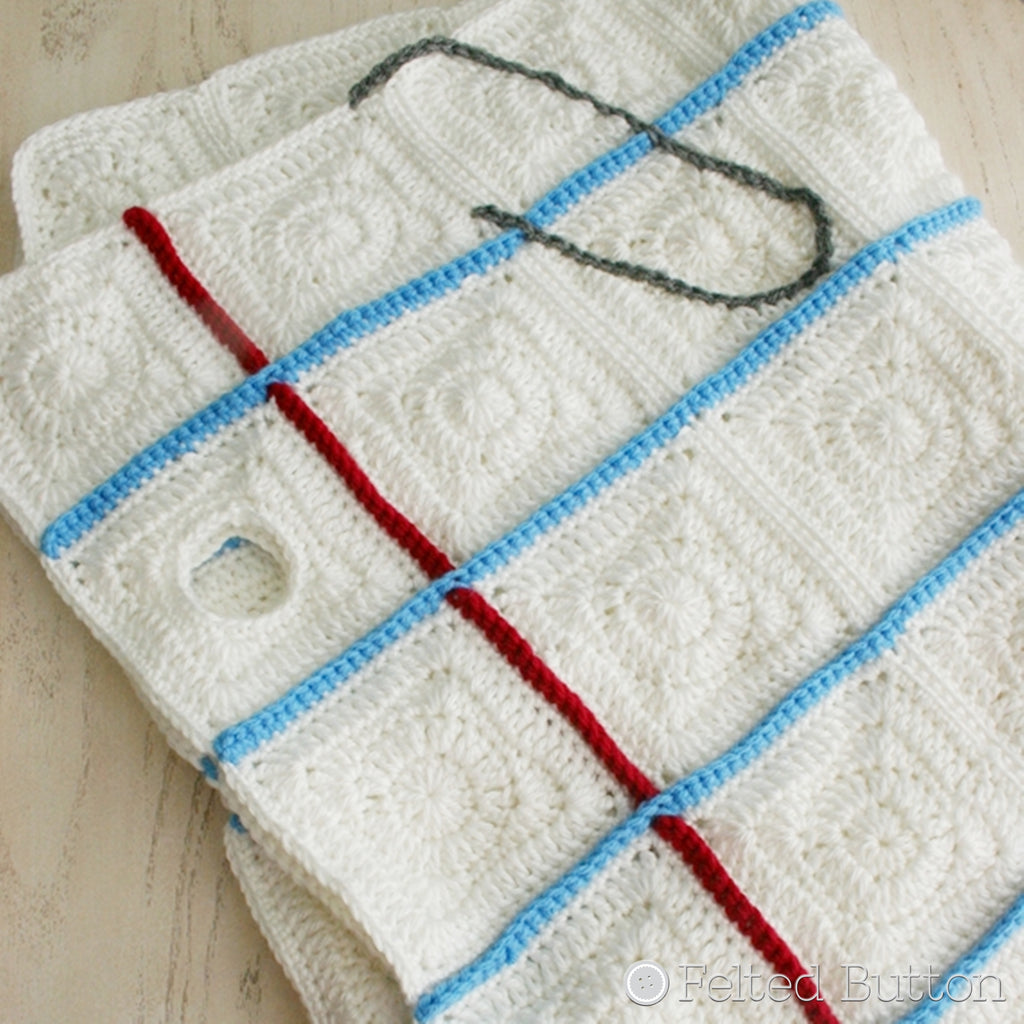 Crochet blanket that looks like notebook paper with a embroidered paper clip, Love Notes Blanket crochet pattern by Susan Carlson of Felted Button