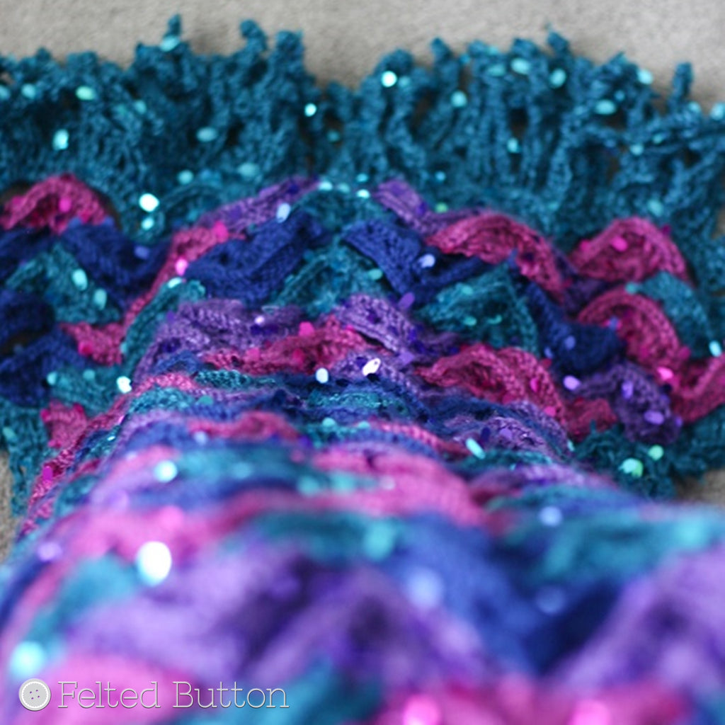Close-up of sparkly crochet "scales" of mermaid tail blanket in pink, purple, blue and teal, Mermaid Me Blanket, colorful crochet pattern by Susan Carlson of Felted Button