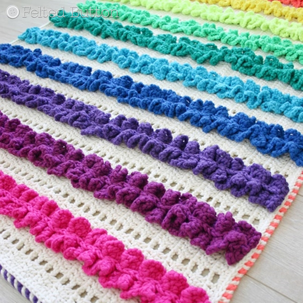 Rainbow of ruffles in rows along a mat or blanket, Rainbow Ruffles Blanket crochet rug or afghan pattern by Susan Carlson of Felted Button