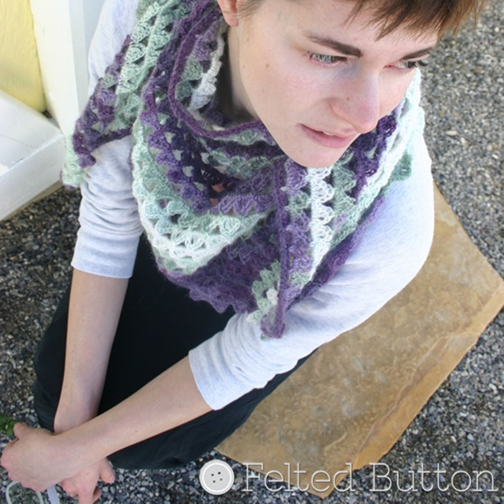 Pretty girl against yellow background wearing purple kerchief scarf around neck, Triangle of Triangles Scarf crochet pattern by Susan Carlson of Felted Button