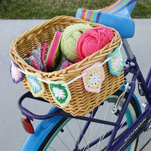 Colorful pentagon cotton flag bunting hanging on bike basket, free crochet pattern by Susan Carlson of Felted Button | Colorful Crochet Patterns