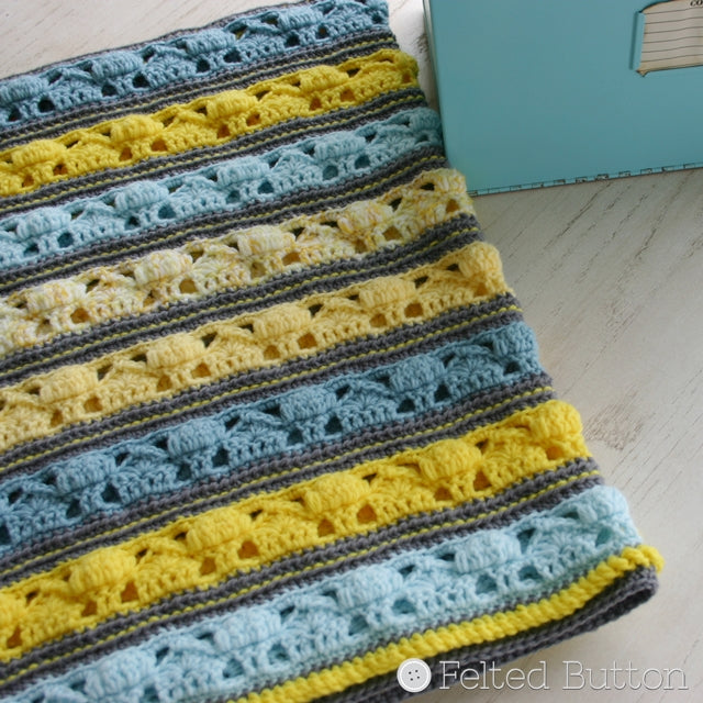 Coming Home Blanket in pastel blues and yellows with little houses and trees on imaginary street, crochet pattern by Susan Carlson of Felted Button | Colorful Crochet Patterns