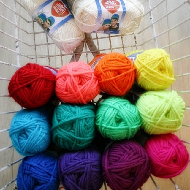 Rainbow of yarn balls in basket, Susan Carlson of Felted Button | Colorful Crochet Patterns