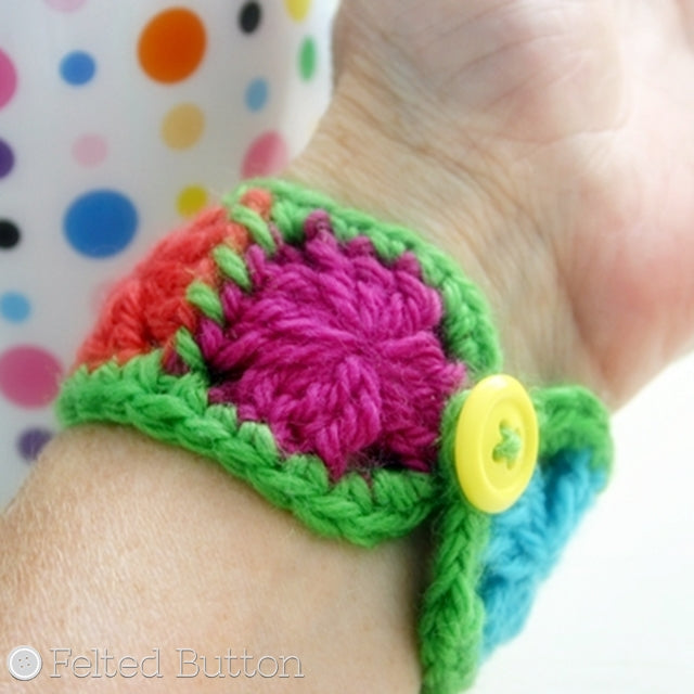 Small colorful single round granny square bracelet in rainbow with yellow button, free crochet pattern by Susan Carlson of Felted Button | Colorful Crochet Patterns, Granny Cuff