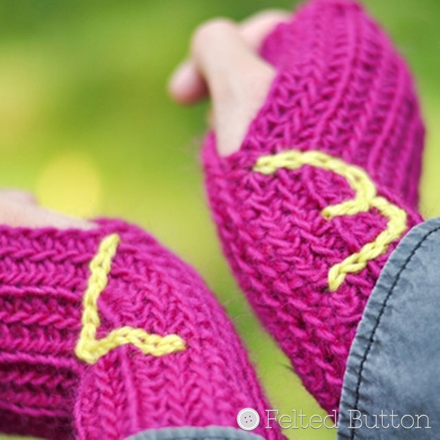 Pink ribbed wristwarmers with <3 at wrists, Ribbed Wristwarmers crochet pattern by Susan Carlson of Felted Button | Colorful Crochet Patterns