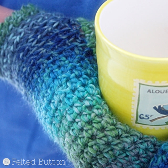 Green and blue mittens holding yellow mug, crochet pattern by Susan Carlson of Felted Button | Colorful Crochet Patterns