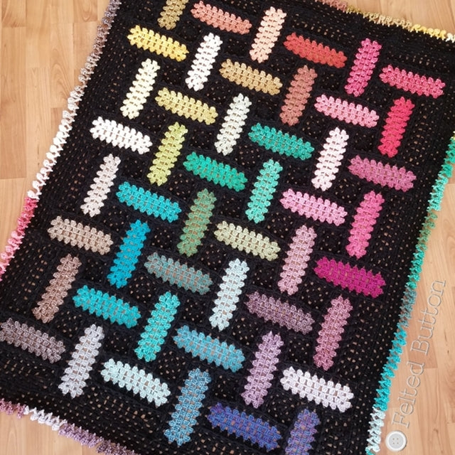 Rainbow and black modem rectangle granny square crocheted blanket with pom pom effing, crochet pattern by Susan Carlson of Felted Button Colorful crochet patterns