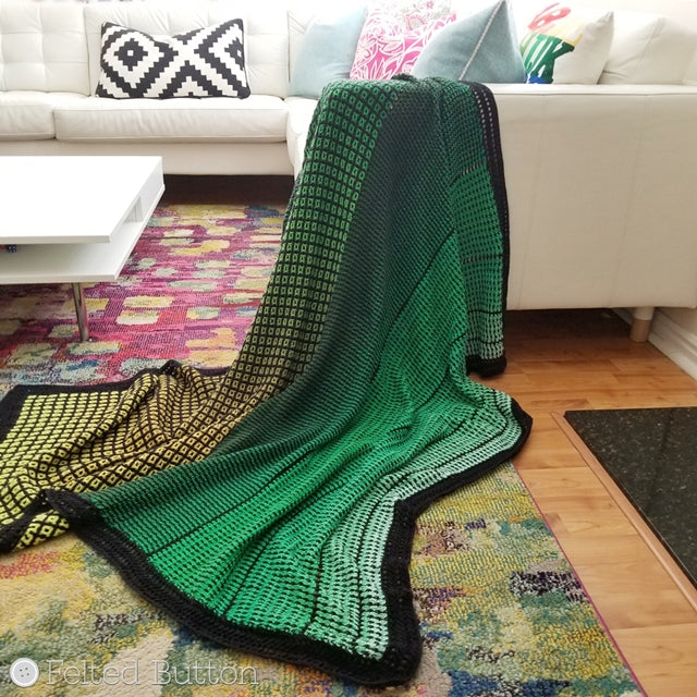 Green ombre crocheted blanket with black trim, made with interlocking crochet and Scheepjes Whirl yarn, free cricket pattern,  by Susan Carlson of Felted Button colorful crochet patterns