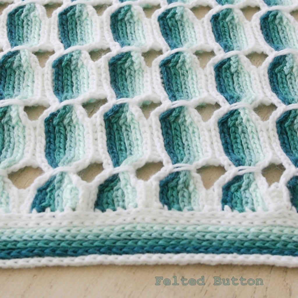 Candy Stick Blanket crochet pattern by Susan Carlson of Felted Button, a turquoise ombre striped blanket with texture