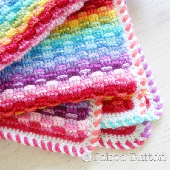 Basket of Rainbows Blanket crochet pattern by Susan Carlson of Felted Button, striped rainbow blanket using Scheepjes Colour Crafter yarn for baby or home