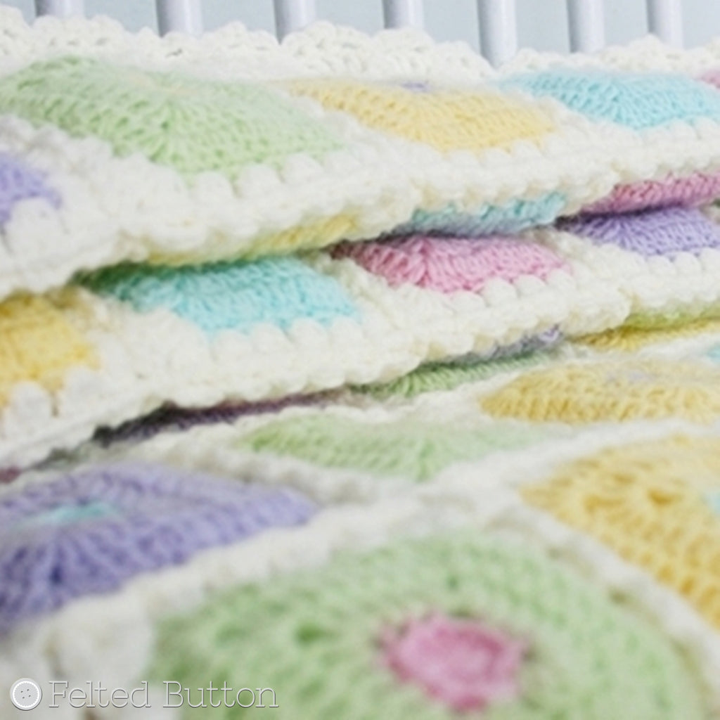 Pastel baby crochet padded quilt in purple, pink, green, blue and yellow, Puffy Patch Blanket crochet pattern by Susan Carlson of Felted Button