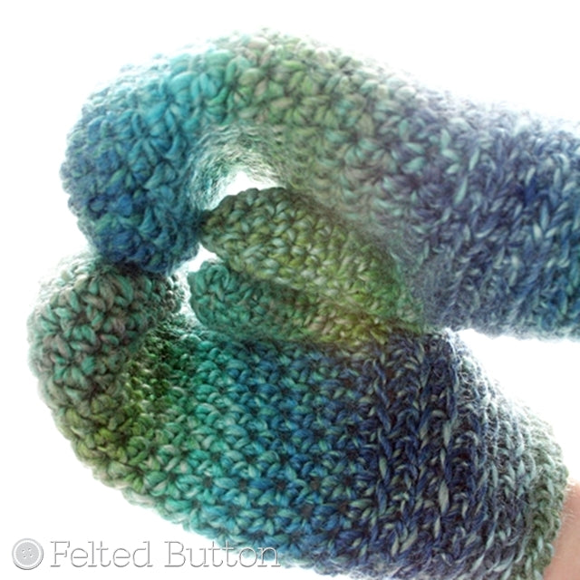 Blue and green mittens with hands holding mug, Sea Ice Mittens crochet glove pattern by Susan Carlson of Felted Button