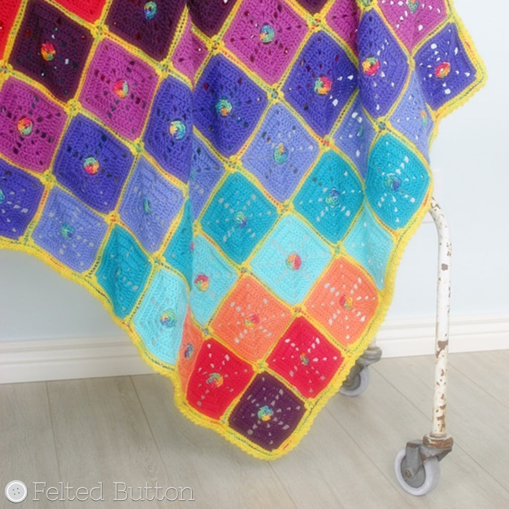 Bright rainbow crochet blanket with granny squares and rainbow center dots, Squarilicious Blanket crochet afghan or baby pattern by Susan Carlson of Felted Button