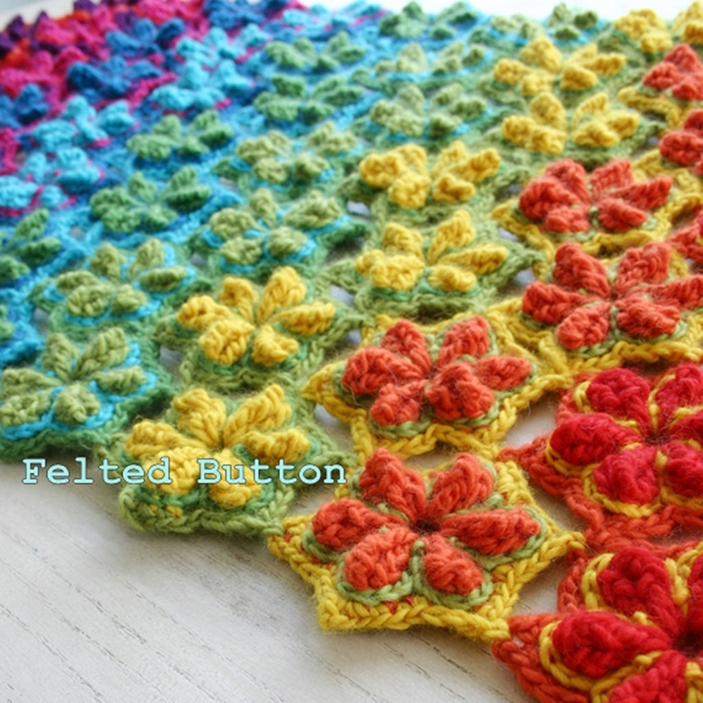 Brilliant colorful rainbow blanket or rug with textured flowers, Star Fruit Blanket or Rug crochet pattern by Susan Carlson of Felted Button