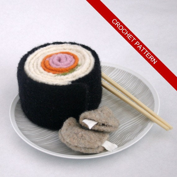 Felted Sushi scarf rolled to look like sushi, Sushi Roll Scarf crochet pattern by Susan Carlson of Felted Button, on plate with felted fortune cookies